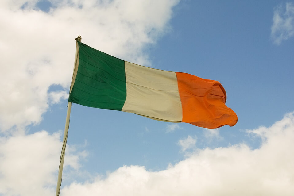 Ireland flag in front of blue sky
